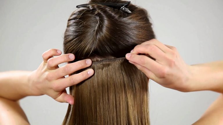 woman putting in hair extensions